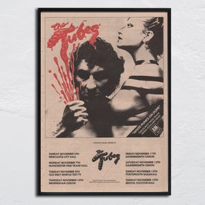 Könnte beinhalten: Gerahmtes Vintage-Poster für The Tubes mit Bandmitgliedern und Konzertdaten. Das Poster hat ein Retro-Design mit roten und schwarzen Grafiken, einschließlich des Textes "White Punks on Dope".