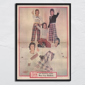 May include: Framed vintage print featuring a group of people in 1970s attire. The image shows people wearing plaid pants and long-sleeved shirts. The text "DISC SPORTING SERIES Bay City Rollers" is at the bottom.