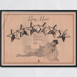 May include: Framed vintage Roxy Music poster. The poster features a sepia-toned image with the band's name in a stylized font. The image includes star-shaped cutouts with band members and a woman in a dress. The poster is in a black frame.