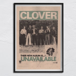 May include: A vintage newspaper advertisement for the band Clover. The ad features a black and white photo of the band members standing in a field. The text reads "Clover" in large green letters and "Their new album is... UNAVAILABLE" in smaller green letters. The ad also includes the album number and copyright information.