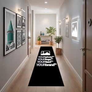 May include: A long black runner rug featuring a white graphic icon of a mountain landscape and the text YOURphoto, YOURlogo, YOURtext, and YOURbrand printed in white, positioned centrally along a hallway floor with light-colored wooden planks.