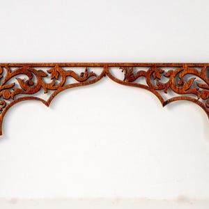 May include: A decorative wooden arch with intricate floral designs, perfect for adding a touch of elegance to any space.