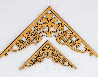 May include: Two wooden corner brackets with intricate floral designs. The larger bracket is on top of the smaller bracket.