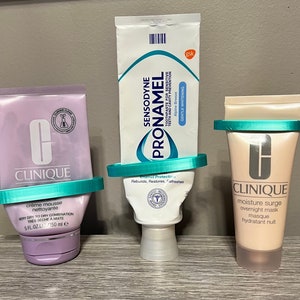 May include: Three tubes of skincare products with turquoise lids and labels. The tubes are labelled "Clinique" and feature a cream mousse, an overnight mask, and a toothpaste for sensitive teeth. The toothpaste is labelled "Sensodyne Pronamel" and is for gentle whitening.