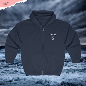 May include: Navy blue zip-up hoodie with a white graphic of a fish hook and the text "OHANA - Important family and friends"