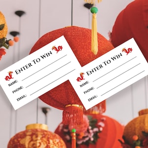 May include: Two white cards with red Chinese dragon designs and the text "ENTER TO WIN" hanging from red Chinese lanterns. The cards have lines for name, phone, and email.