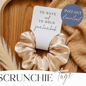 May include: A beige satin scrunchie with a white tag that reads "TO HAVE and TO HOLD your hair back." A blue circle with "INSTANT download" is visible. The scrunchie is on a wooden tray with a beige scarf and decorative grass.