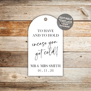 May include: White wedding favor tag with black text that reads "To Have and To Hold, incase you get cold!" with the names "MR & MRS SMITH" and the date "16.11.24".