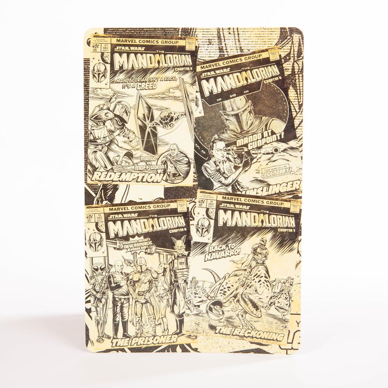 May include: A rectangular Star Wars themed notebook featuring comic book covers of The Mandalorian. The covers are in black and white and include text such as "Mando at Gunpoint!" and "The Prisoner".