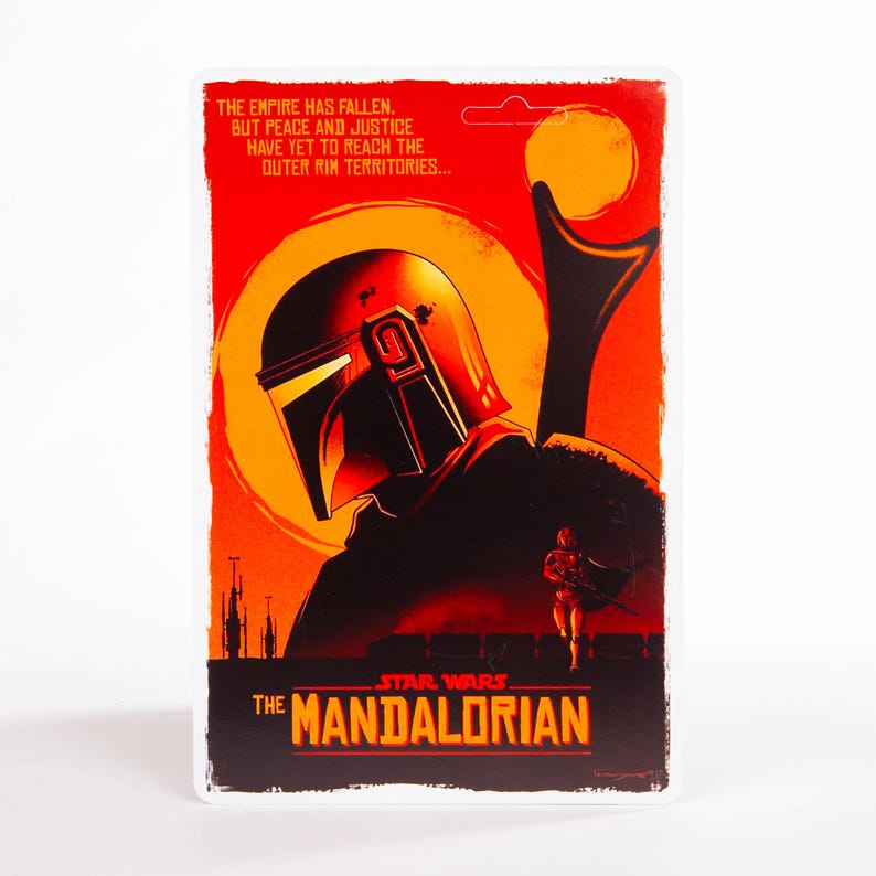 May include: A rectangular Star Wars: The Mandalorian poster with a red and orange background. The poster features a helmeted figure and the text "THE EMPIRE HAS FALLEN..." and "THE MANDALORIAN".