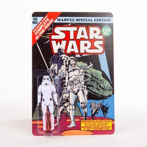 May include: A Star Wars Marvel Special Edition action figure, featuring a white Stormtrooper figure on a retro comic book-style card. The card has the Star Wars logo, illustrations of characters, and text that reads "The Entire Story! Complete in One Issue!"