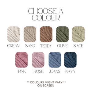 May include: A color chart featuring nine yarn samples in various shades, including cream, sand, teddy, olive, sage, pink, rose, jeans, and navy. The text "CHOOSE A COLOUR" is at the top, with the disclaimer "COLOURS MIGHT VARY ON SCREEN" at the bottom.