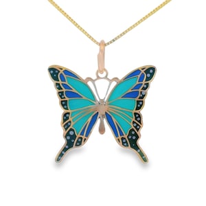 May include: A gold chain necklace with a blue and green enamel butterfly pendant.