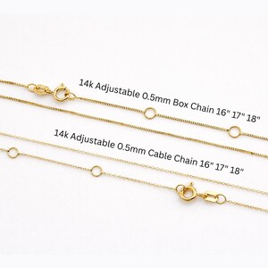 May include: Two gold-colored necklaces with clasps and adjustable chain lengths. The text reads "14k Adjustable 0.5mm Box Chain 16" 17" 18"" and "14k Adjustable 0.5mm Cable Chain 16" 17" 18"". The chains are displayed against a white background.