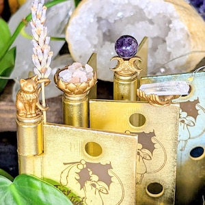 Decorative witchcraft hinge head set for doors, each holding a natural element like herbs, flowers, crystals, or stone