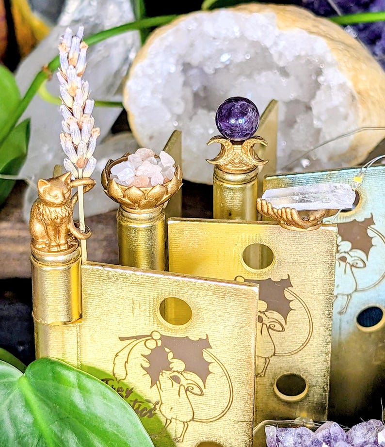 Decorative witchcraft hinge head set for doors, each holding a natural element like herbs, flowers, crystals, or stone