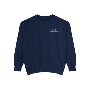 May include: A navy blue long-sleeved sweatshirt with the text "No1 guy in the group" printed on the front in white.