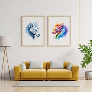 May include: Two framed watercolor paintings of dragon heads. The left painting features a white dragon head with blue accents. The right painting features a multi-colored dragon head with pink, orange, yellow, blue, and purple accents.
