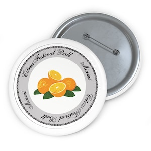 May include: White button with a gray circle containing the text "Citrus Festival Ball Miami" and a graphic of three oranges. The text is repeated on the bottom of the circle.