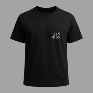 May include: Black crew neck t-shirt with the text "Oops! Shirt Happnd" in white script on the upper left chest. The shirt has short sleeves and a simple, classic design, suitable for casual wear.