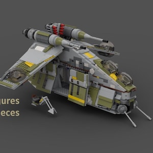 May include: A detailed model of a spacecraft, primarily gray, green, and yellow, with two large engines on top. The text "10 Minifigures 1333 pieces" is visible. The model has wings and a cockpit.