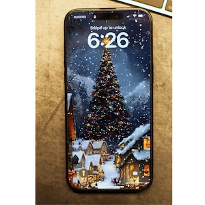 May include: A smartphone displaying a Christmas-themed lock screen with a snowy scene, a large decorated Christmas tree, and the time 6:26.