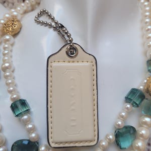 Coach Hang Tag Milky White Patented Leather Finish Medium Gloss Silver tone Hardware Keychain Handbag Charm Accessory 2.5&#39;&#39;