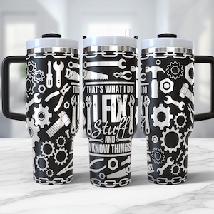 May include: Three black and white stainless steel travel mugs with lids. The mugs are covered in a pattern of tools and gears. The middle mug has the text "That's what I do I fix stuff and I know things".