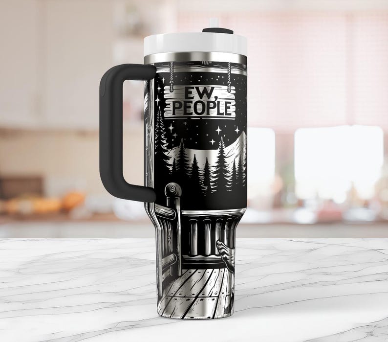 May include: A black and silver stainless steel travel mug with a black handle. The mug has a graphic of a cabin in the woods with a sign that reads "Ew, People".