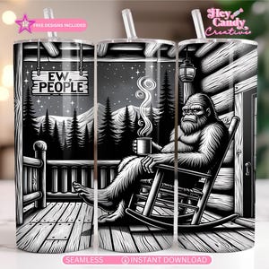 May include: Black and white tumbler featuring a Bigfoot character relaxing on a porch, holding a mug. The design includes a sign that reads "EW PEOPLE" and a mountain and forest scene. The tumbler has a straw and a pink star graphic.