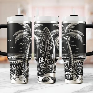 May include: Black and white stainless steel tumbler with a palm tree and surfboard design. The tumbler has a black handle and a straw. The text on the surfboard reads "Life is better at the beach".