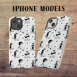 May include: Two white iPhone cases with a black and white pattern of ghosts and cats. The text "IPHONE MODELS" is at the top of the image.