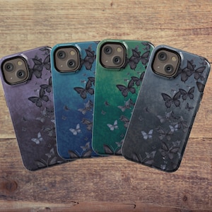 May include: Four different phone cases with a butterfly pattern. The cases are in shades of blue, green, and gray. Each case has a different butterfly design.