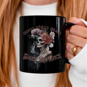 May include: Black coffee mug with a white skull wearing a floral crown and the text "Good girls read dark romance".