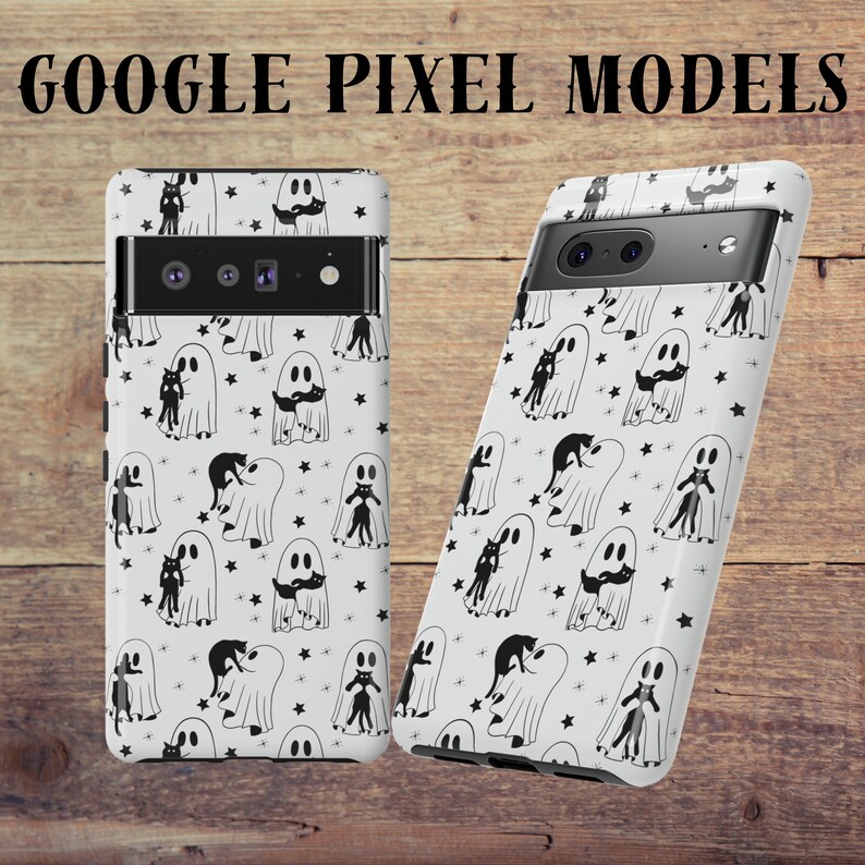May include: Two white Google Pixel phone cases with a black and white ghost and cat pattern. The cases have a black camera bump with two lenses.
