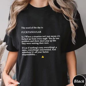 May include: Black t-shirt with white text that reads "The word of the day is: FUCKTANGULAR" followed by a definition. The shirt also has a small yellow hazard symbol.
