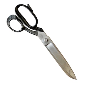 May include: Large, vintage tailor's shears with black handles and silver blades. The shears are angled, with one blade longer than the other. The handles have a classic loop design for easy grip and control. The metal has a slightly worn appearance.
