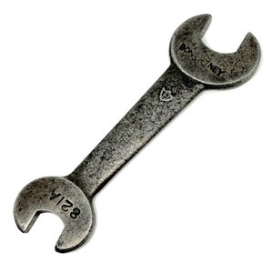 May include: A double-ended open-end spanner made of dark, weathered steel. The tool features the text BONNEY stamped on one end and the number 821A stamped on the other end. A small shield-shaped logo is visible on the central shaft of the spanner.