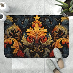 May include: A rectangular floor mat featuring a symmetrical damask pattern with vibrant orange, yellow, and deep blue acanthus leaf motifs set against a solid black background. The design displays intricate, swirling organic shapes.