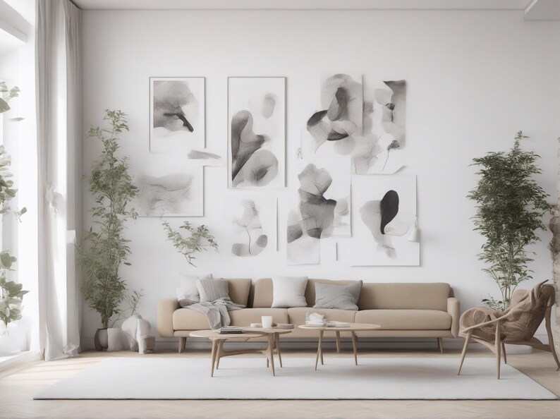May include: A beige sofa with gray pillows sits in front of a wall featuring a gallery of abstract black and white ink wash paintings. Two wooden coffee tables are placed in front of the sofa, with a wooden armchair and potted plants nearby.