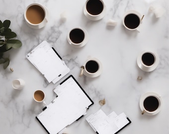 May include: A collection of eight white ceramic coffee cups filled with black or light brown coffee, arranged alongside three black-bound planners with white pages, all positioned on a white marble surface with a small green leafy plant.