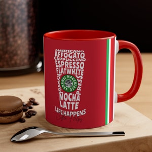 May include: Red coffee mug with a white design featuring a list of coffee drinks, including Americano, Affogato, Cappuccino, Espresso, Flat White, Mocha, Latte, and the text "Life Happens Coffee Helps".