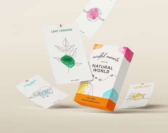 May include: A box of 38 mindfulness cards with the title "Mindful Moments with the Natural World". The cards feature watercolor illustrations of nature scenes and inspirational quotes.