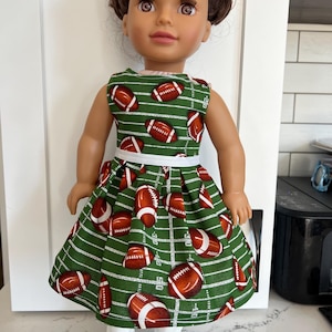 18 inch doll dress, adorable football themed cotton dress , white ribbon accent.  Hook and loop enclosure for easy on and off.