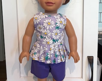 18 inch doll short set. Flower top/purple shorts.  Hook and loop enclosure on top and elastic on the shorts for easy on and off.