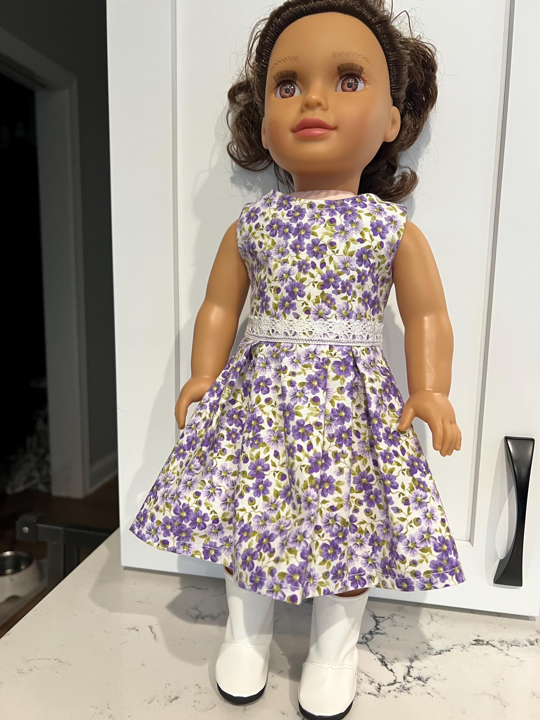 18 inch doll dress, adorable purple flower pattern, white lace accent.  Hook and loop enclosure for easy on and off.