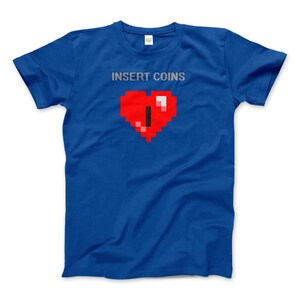 May include: A royal blue t-shirt with the text "INSERT COINS" and a pixelated red heart with a black pixel in the center.