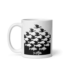 May include: White ceramic mug with a black and white illustration of a flock of geese flying in formation, with the geese turning into fish as they descend. The image is a classic optical illusion.