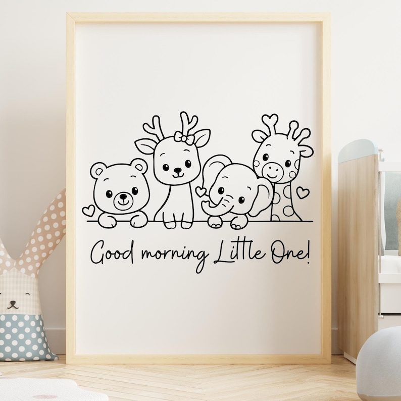 May include: A framed print featuring a black and white illustration of a bear, deer, elephant, and giraffe. The phrase "Good morning Little One!" is written below the animals. The artwork is in a light wood frame.