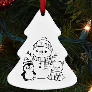May include: White Christmas tree ornament featuring a snowman, penguin, and bear in black and white. The snowman wears a hat and scarf, the penguin a hat, and the bear a scarf. A red ribbon is attached for hanging.